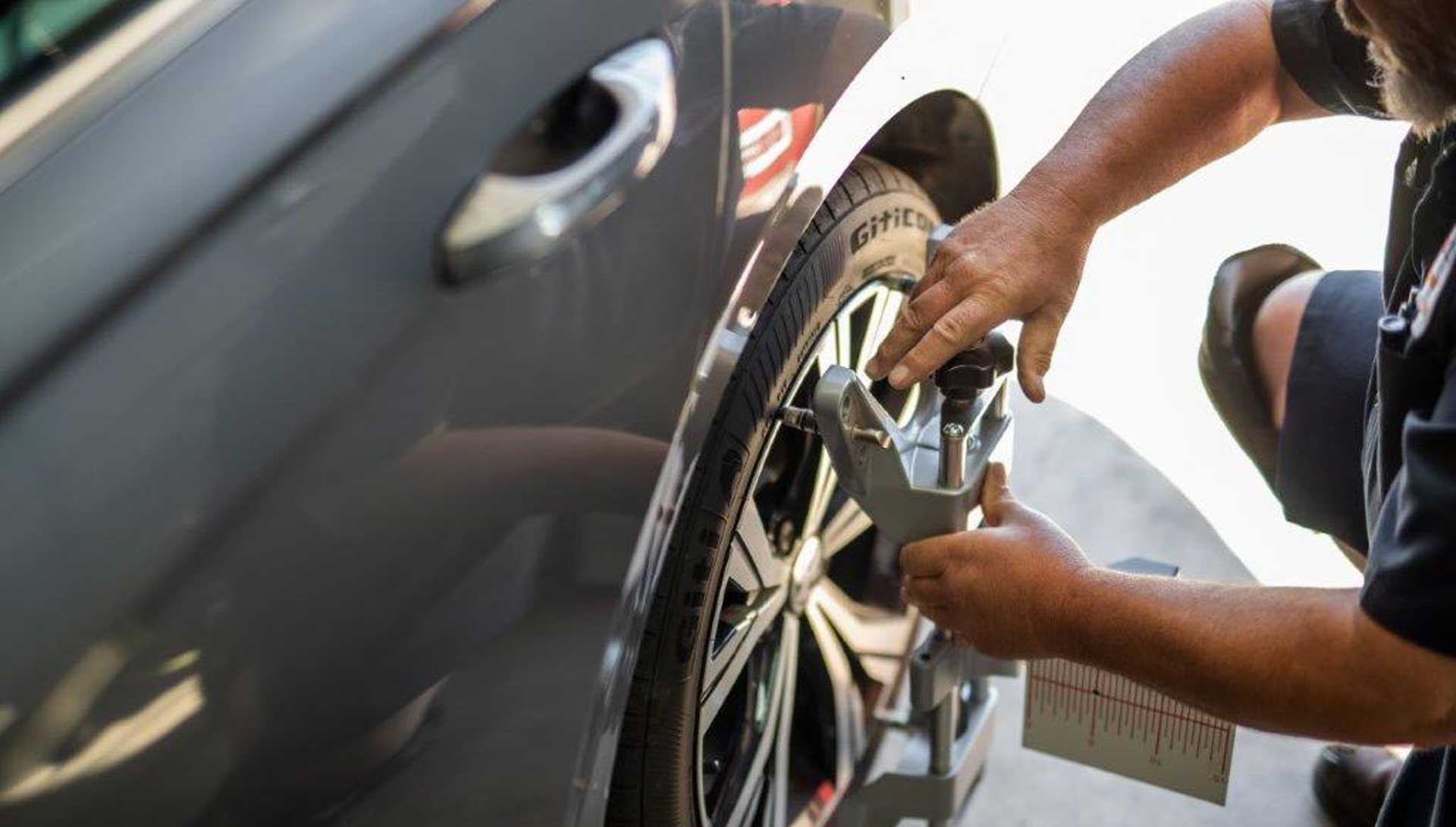 Tech doing wheel alignment